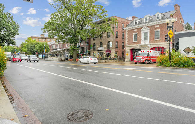 A street view with cars, buildings, and a fire truck.