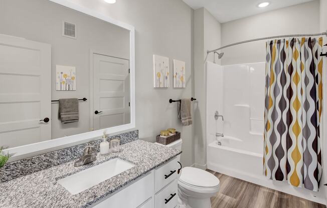 a bathroom with a sink and a shower and a toilet