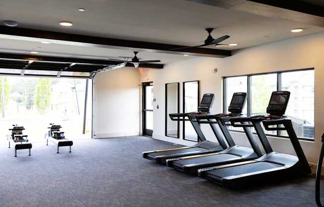 A gym with treadmills and exercise equipment.