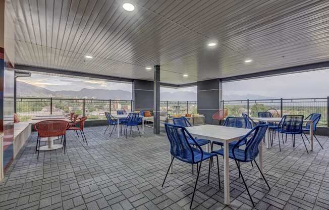 a cafeteria with tables and chairs and a view of mountains