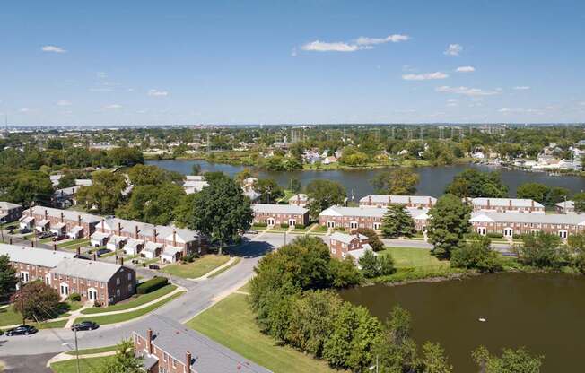 A view of a town with a lake and buildings.