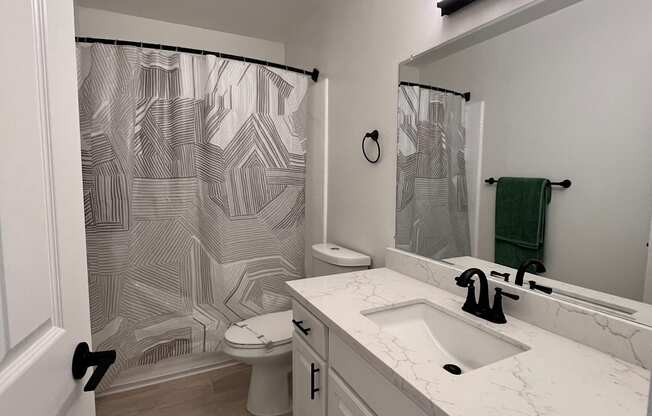 a bathroom with a sink and a shower and a toilet at Campbell West Apartments, Campbell