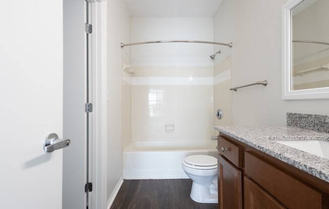 a bathroom with a toilet and a sink and a shower