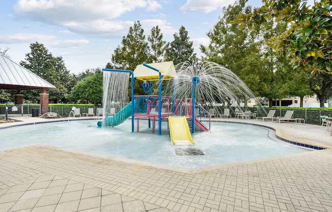 A water park with a slide and a waterfall at Wynnfield Lakes Apartments in Jacksonville, FL