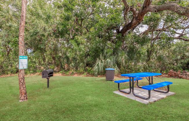 a blue bench in a park