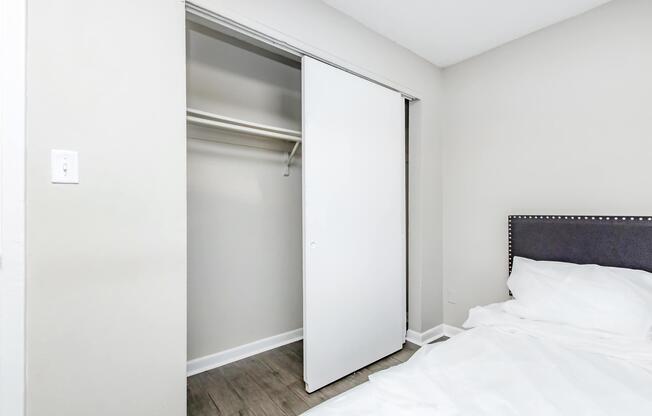 a bedroom with a bed and a mirror