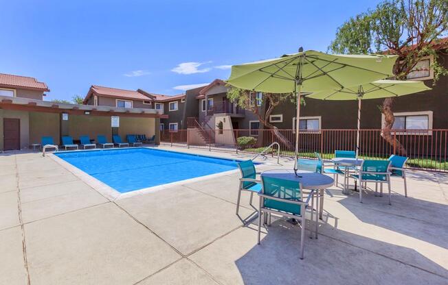 a house with a pool table with a blue umbrella