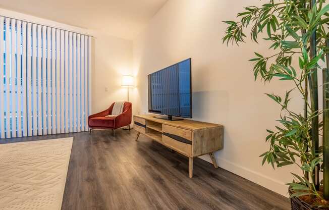 a living room with a couch and a tv on a wooden table