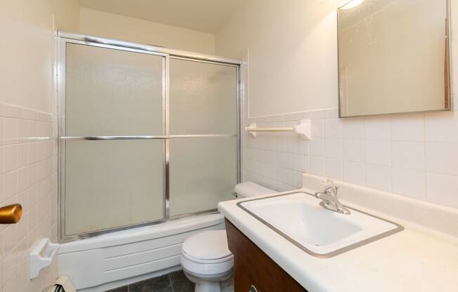 a bathroom with a sink toilet and shower. Fargo, ND Islander Apartments