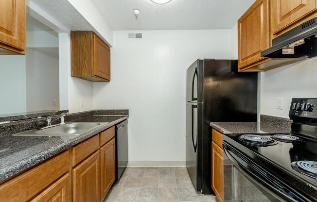 a kitchen with stainless steel appliances and wooden cabinets