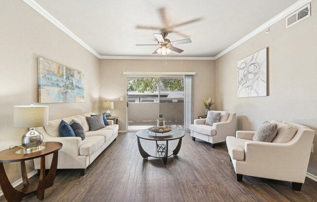 a living room with furniture and a ceiling fan