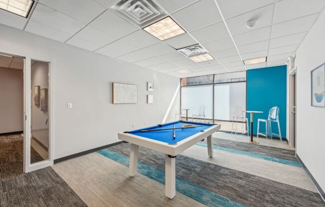 a games room with a pool table