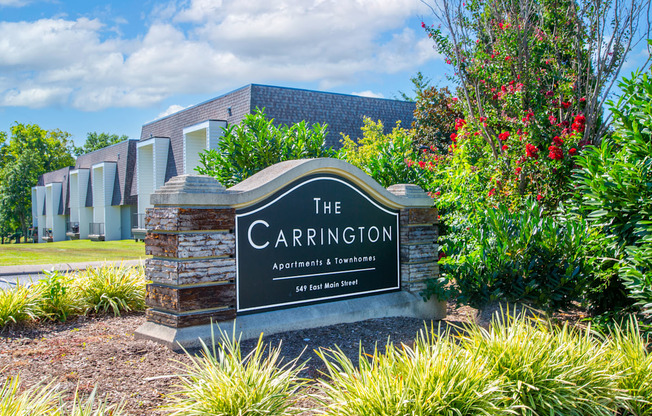 The Carrington Apartments sign in front of a building.