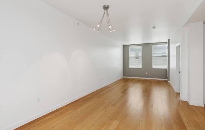 A room with wooden floors and a chandelier.