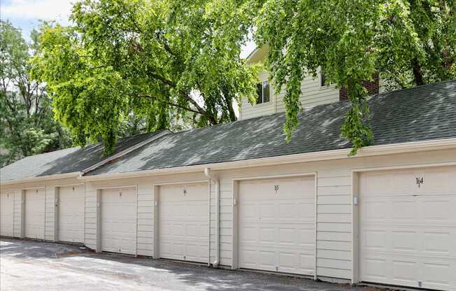 A row of white garage doors are closed.