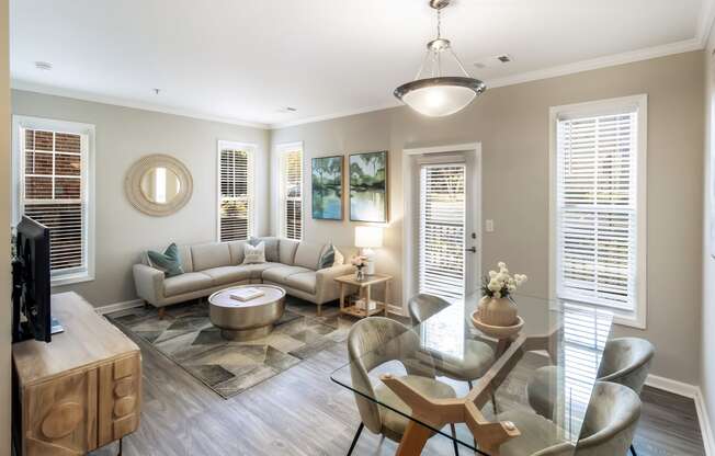 a living room with couches and a table and chairs