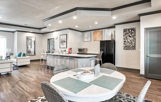 A modern dining room with a white table and chairs.