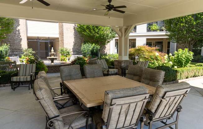 a covered patio with a table and chairs