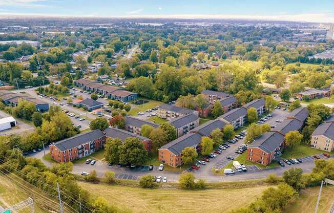 A bird's eye view of a residential area with houses and cars.