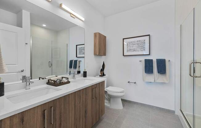 A bathroom with a white sink and a white toilet.