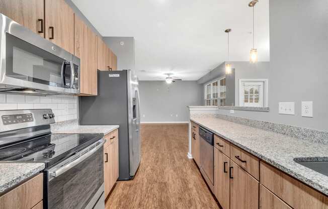 a kitchen with granite counter tops and stainless steel appliances