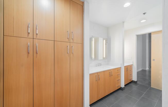 a bathroom with wooden cabinets and a sink and a mirror