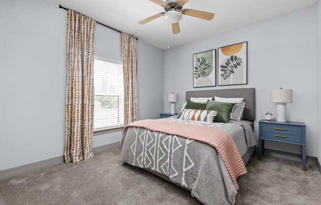a bedroom with a bed and a ceiling fan at the Vue apartments in Indianapolis