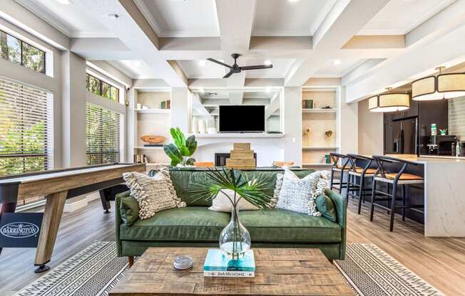 a living room with a green couch and a coffee table