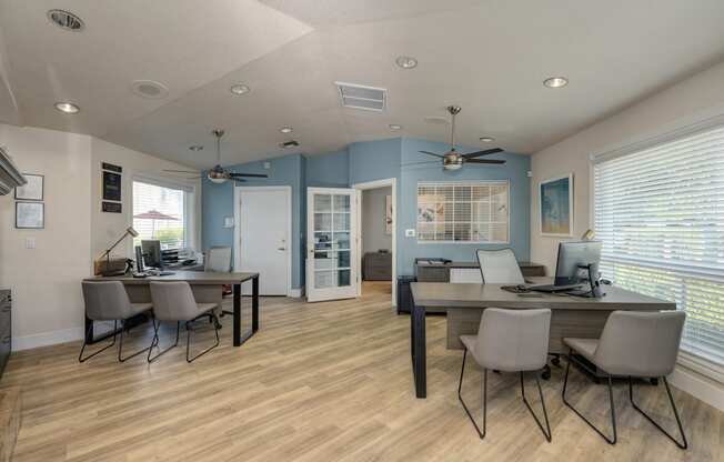 Leasing office with desks and chairs for leasing agents to work with prospective renters and residents.