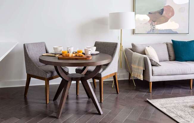 A modern dining room with a round table and chairs at The Pennsylvanian Apartments, Pittsburgh, PA