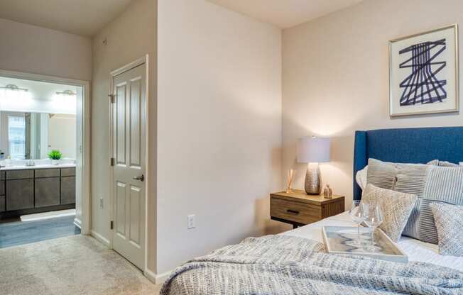 a bedroom with a bed and a bathroom with a sink