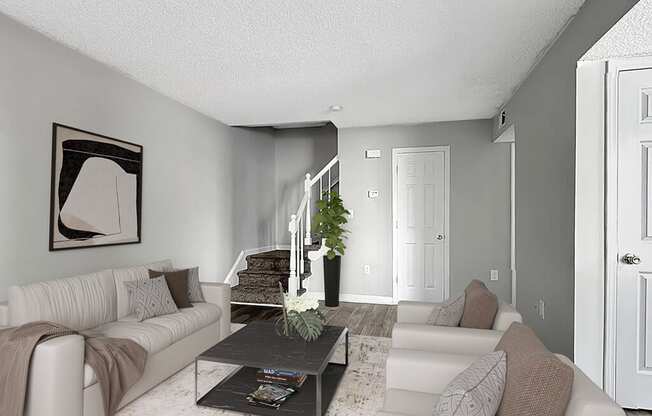 a living room with white couches and a coffee table