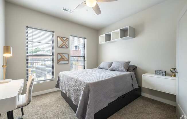 a bedroom with a bed and a desk with a chair