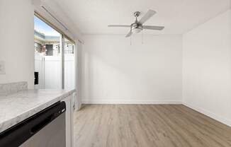 A room with a ceiling fan and a marble countertop.