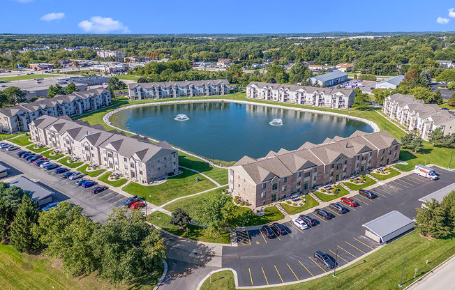 A beautiful community with a large pond in the middle at Oak Shores Apartments in Oak Creek, WI
