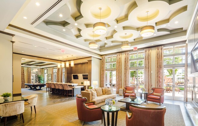 A large, well-lit room with a variety of seating options and a fireplace.