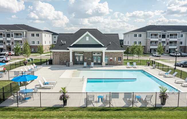 Overview of the clubhouse and pool, various seats around pool.