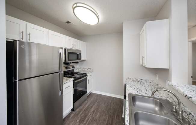 a kitchen with stainless steel appliances and granite counter tops