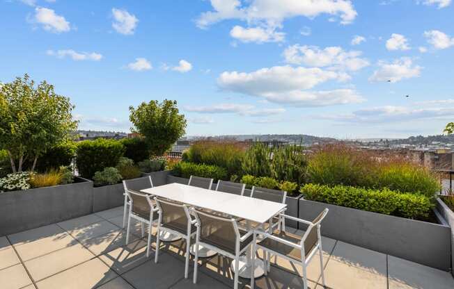 a patio with a table and chairs on a roof