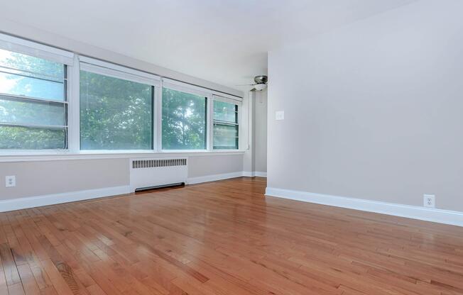 a room with wood floors and a large window
