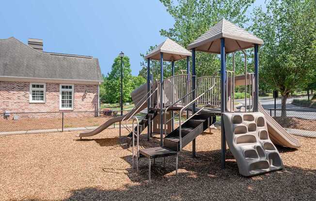 A playground with a slide and a gazebo.