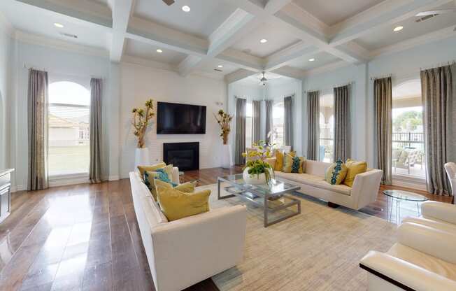 a living room with a coffered ceiling and hardwood flooring