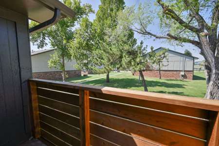 A wooden fence in the foreground with a residential area in the background.