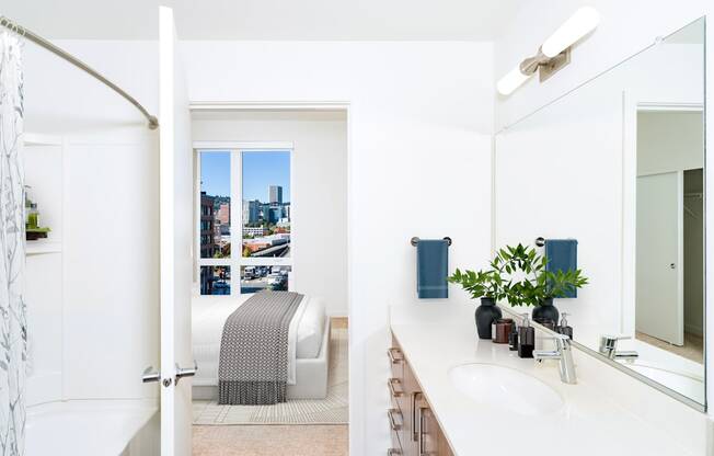 A bathroom with a white sink and a mirror.