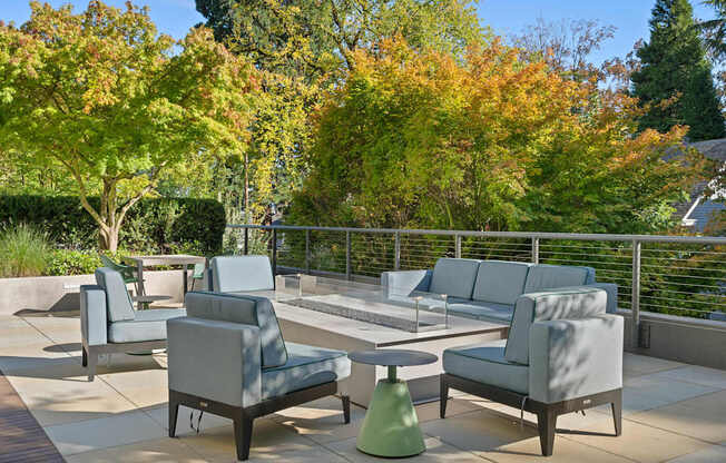 a seating area on a patio with chairs and tables