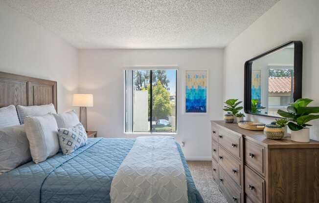 a bedroom with a large bed and a large window