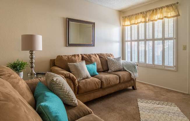 Riverstone living room with couches, carpet flooring and nice natural lighting