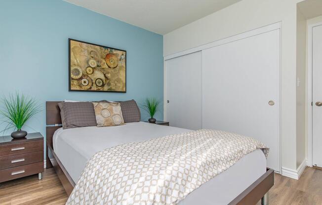 a bedroom with a bed and desk in a room