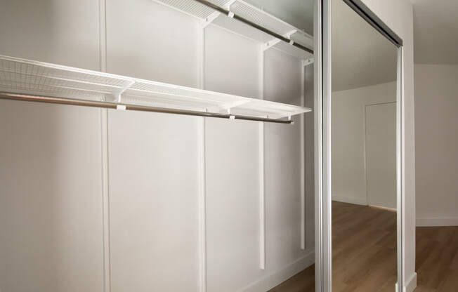 A white refrigerator with its door open in a room.