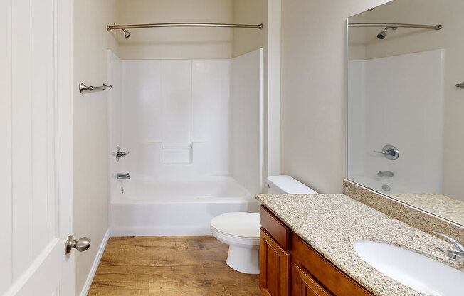 a bathroom with a toilet and a shower and a sink